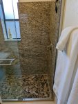 Granite shower with pebble floor